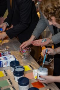 Three participants preparing arts and craft for Design for a Difference Workshop 2025