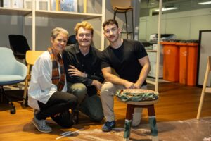Three attendees smiling at camera at Design for a Difference Event 2025