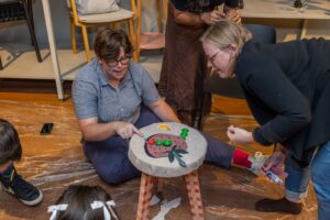 Lady pointing at stool design at Design for a Difference Workshop 2025