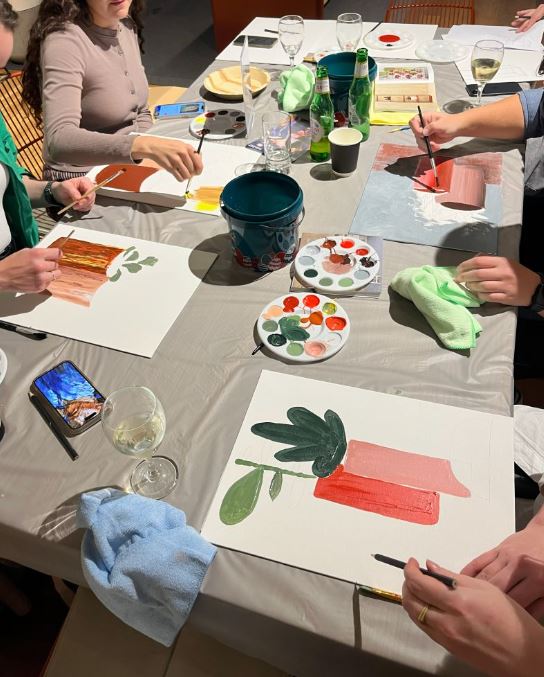 Four participants painting at Design for a Difference event 2026