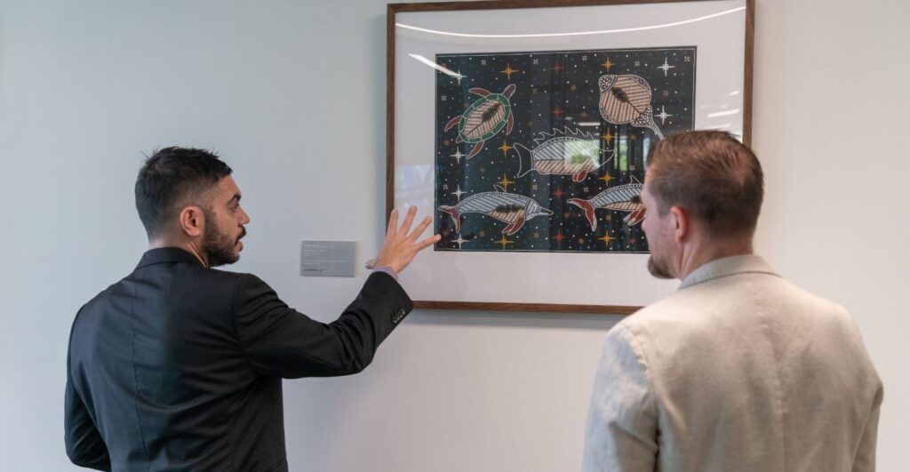 Caloundra Library Opening Event Bunin Director explaining Indigenous painting to attendee at Caloundra Library Opening Event
